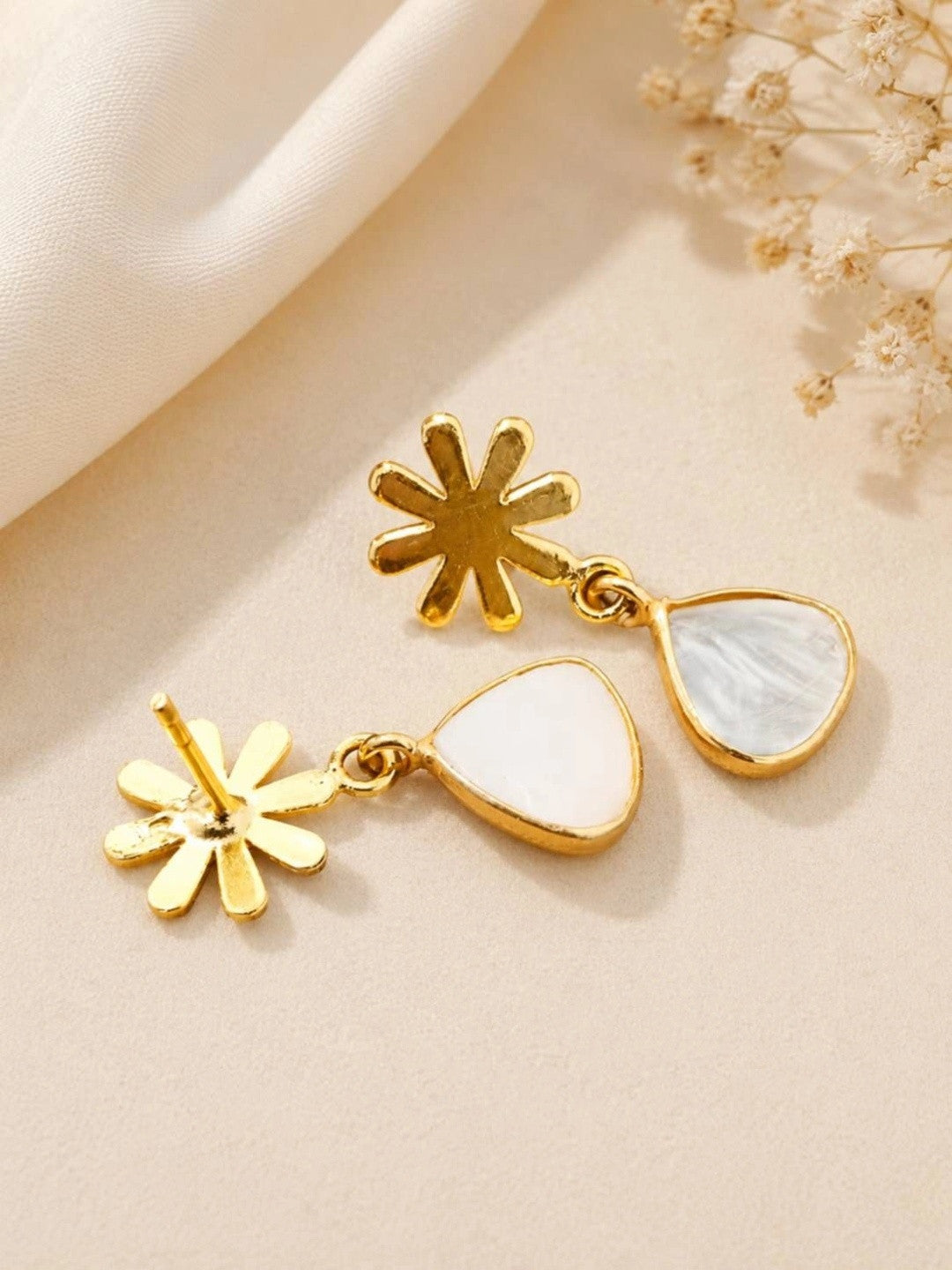 Back view of gold-plated snowflake drop earrings showing push-back stud fitting and teardrop stone pendants
