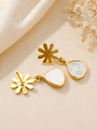 Back view of gold-plated snowflake drop earrings showing push-back stud fitting and teardrop stone pendants