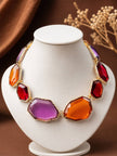 Multicolour resin stone choker necklace displayed on a white jewellery bust with warm brown backdrop