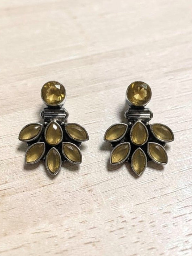 Oxidised silver citrine ear jacket earrings laid flat on a light wooden surface showing full fan detail