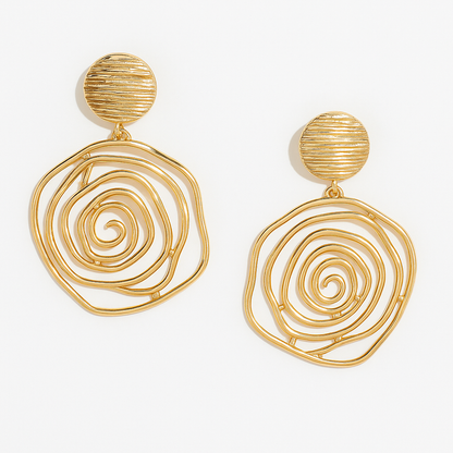 Gold spiral earrings on a white background