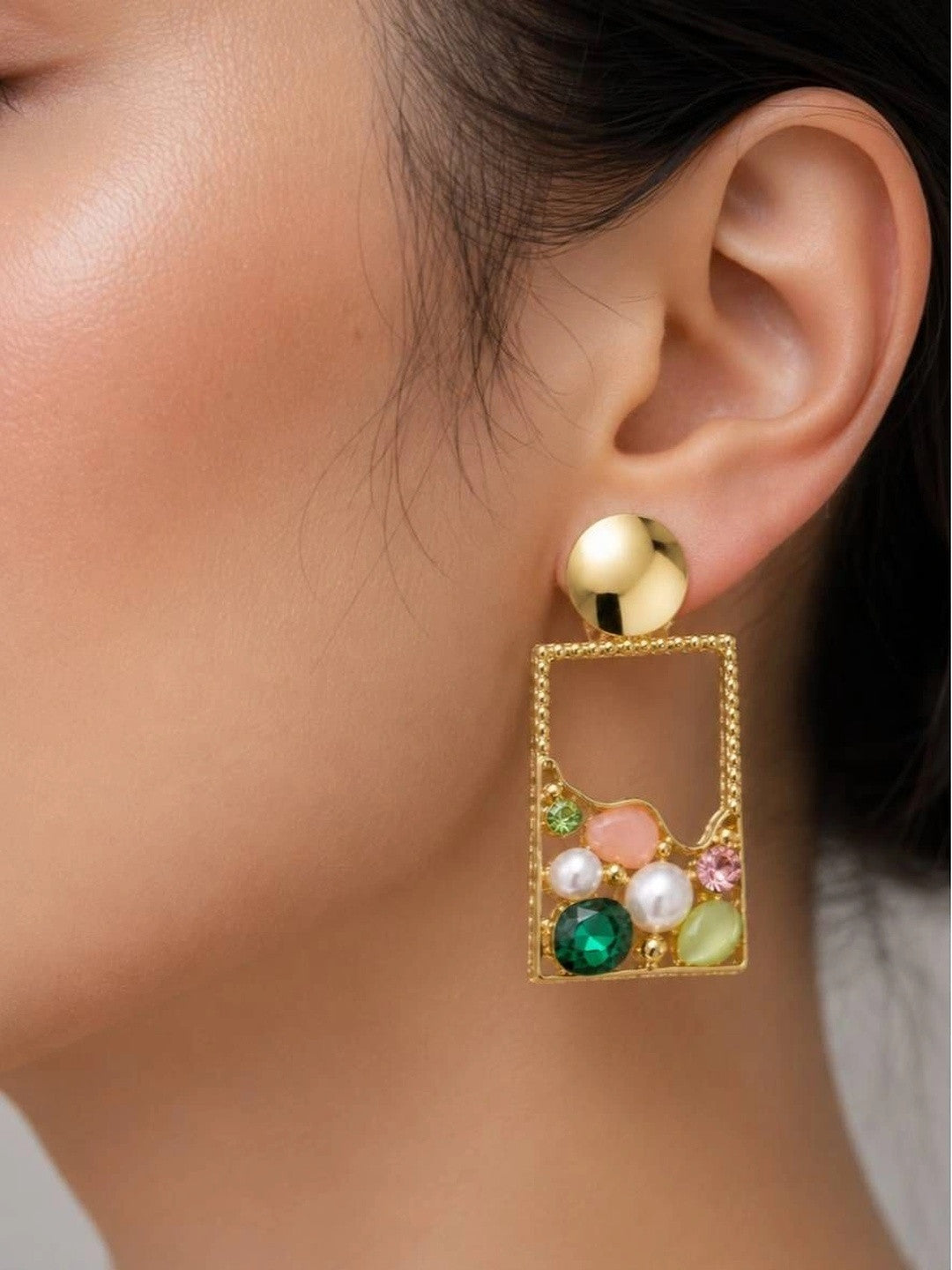 Gold rectangle crystal drop earring worn on a model's ear showing full side profile