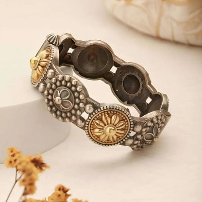 Decorative bracelet with intricate designs on a light background