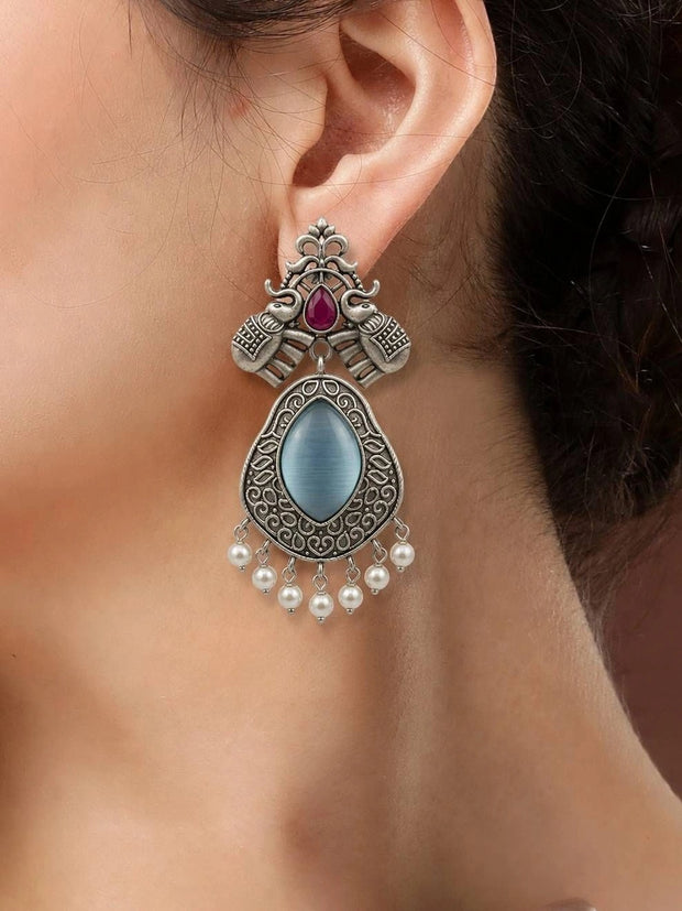 Oxidised silver elephant teardrop earring worn on a woman's ear showing full length and pearl drop fringe