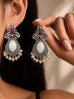 Woman wearing oxidised silver elephant chandbali earrings while holding the second earring near her face