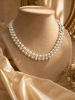 Pearl crystal choker necklace displayed on a beige velvet jewellery bust with gold mirror and satin drape