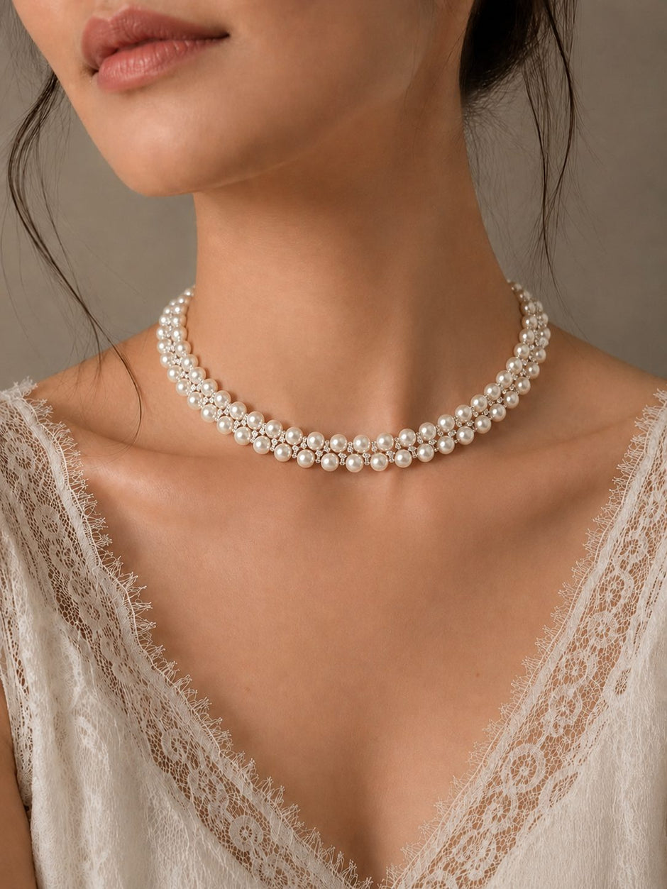 Model wearing two-row pearl crystal choker necklace with white lace neckline bridal top