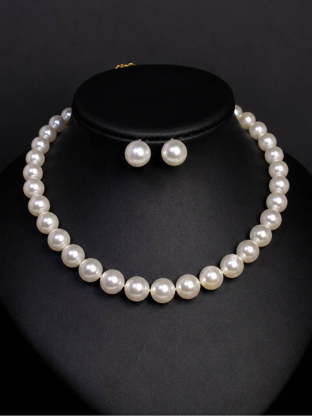 White faux pearl choker necklace displayed on a black bust with matching round pearl stud earrings
