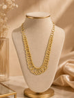 Gold-plated rings chain necklace displayed on a beige velvet jewellery bust against a warm backdrop