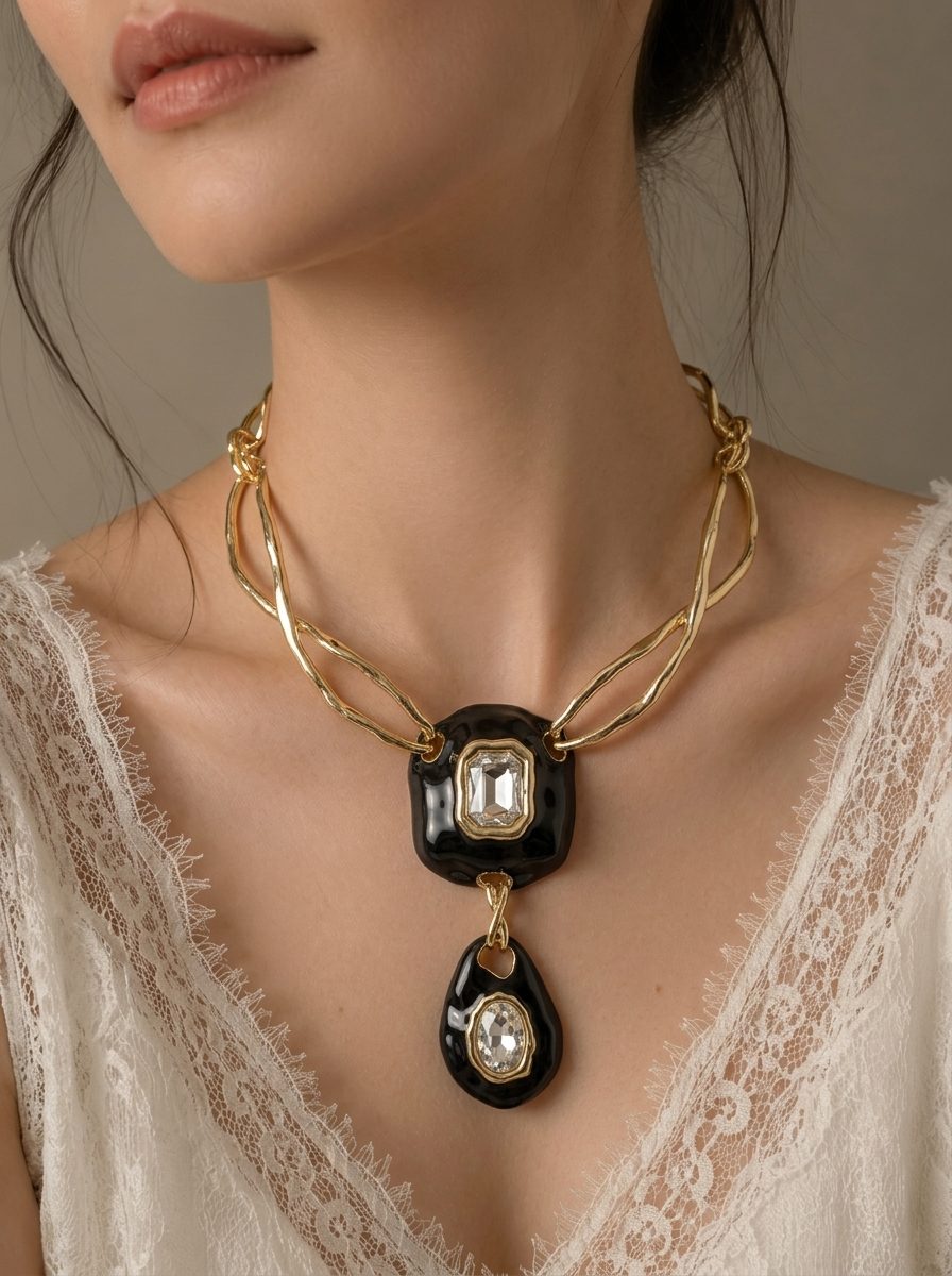 Woman wearing black enamel gold-plated pendant necklace over a white lace neckline, front view