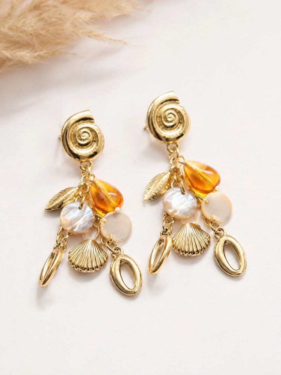 Both gold charm drop earrings flat lay showing spiral stud, leaf, shell and oval drop details