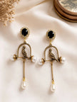 Both bird cage earrings laid flat on ivory silk fabric, showing black crystal halo studs and full drop length