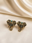 Pair of antique gold elephant head studs with filigree detailing and turquoise cabochons on cream satin fabric