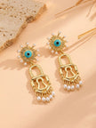 Pair of gold evil eye lock drop earrings laid flat showing turquoise enamel and pearl drops