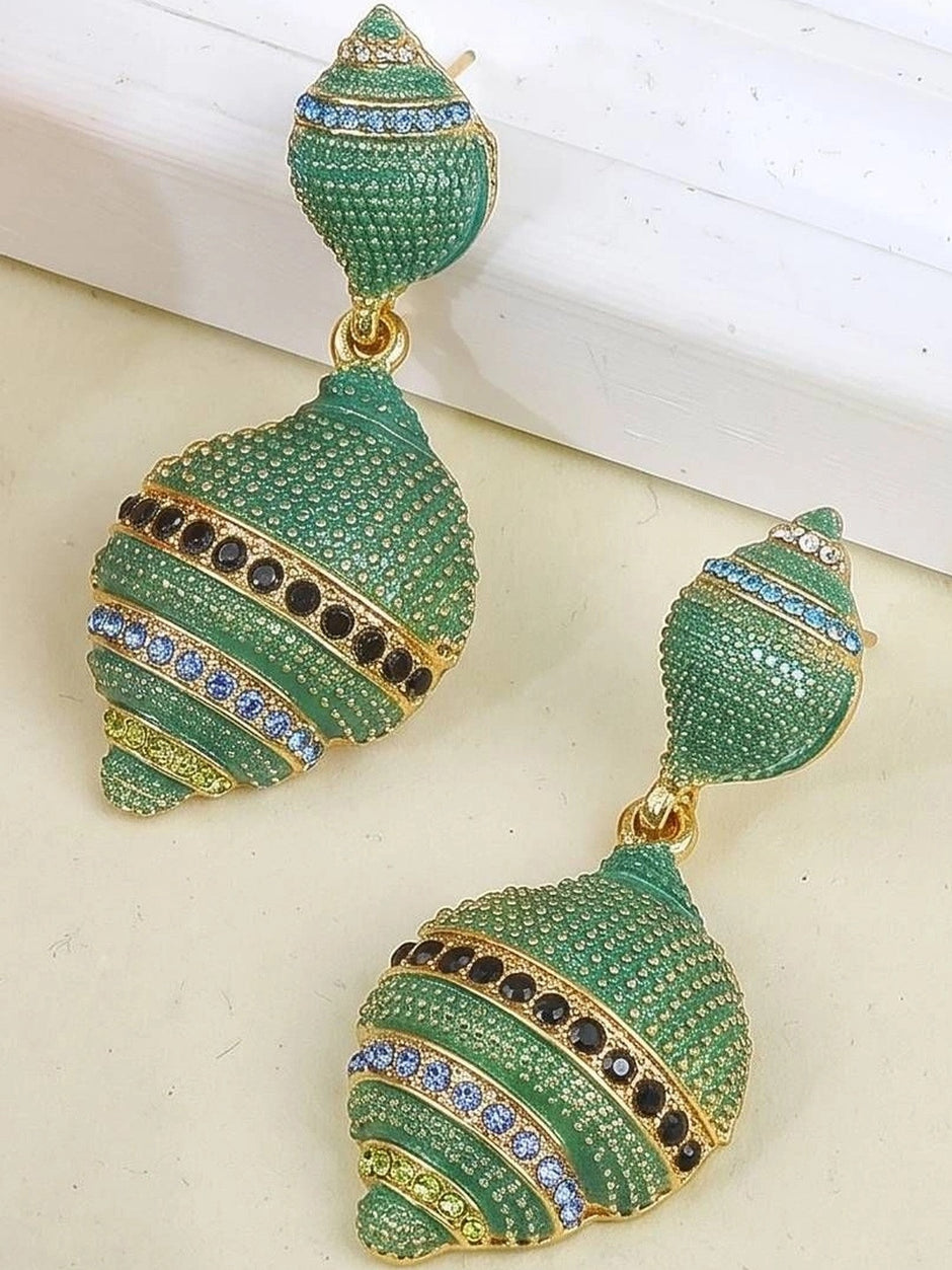 Green pavé shell drop earrings with black and blue crystal stripe details displayed on a light surface
