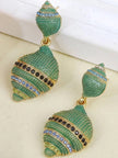 Green pavé shell drop earrings with black and blue crystal stripe details displayed on a light surface