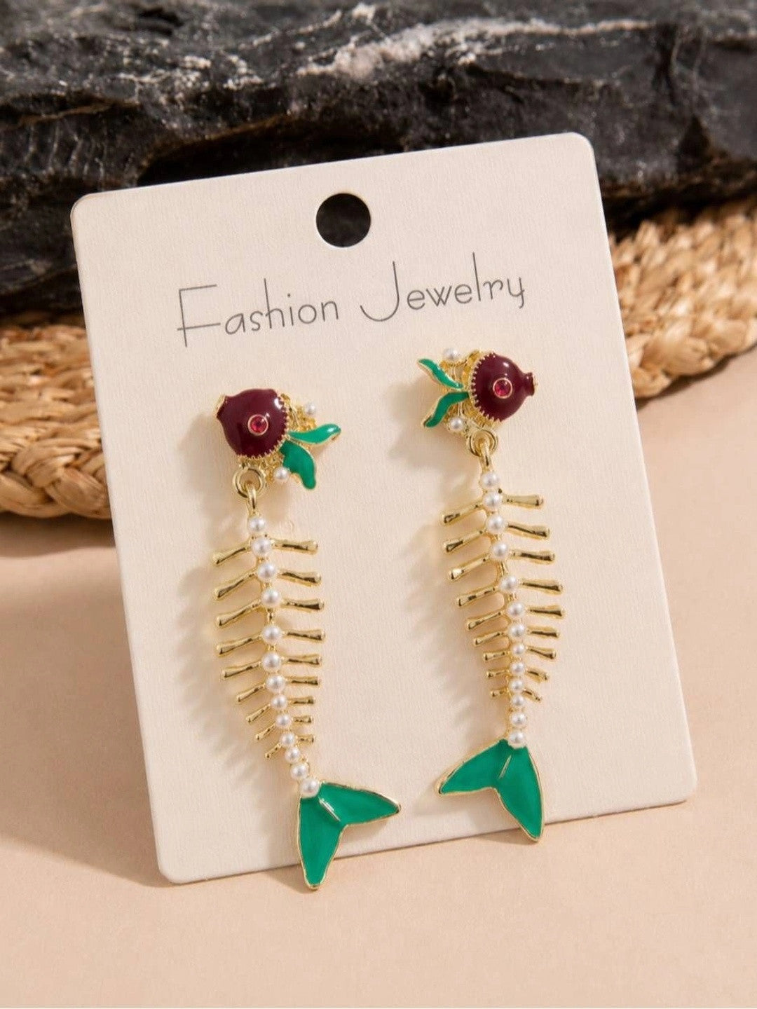 Fish skeleton drop earrings displayed on Fashion Jewelry card showing full length and detail