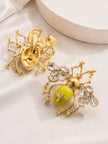 Back and front view of gold bee earrings showing push-back stud fastening and yellow enamel abdomen detail