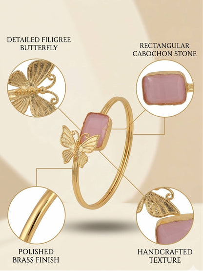 Annotated flat-lay of butterfly cuff bracelet highlighting filigree butterfly, cabochon stone, brass finish and handcrafted texture