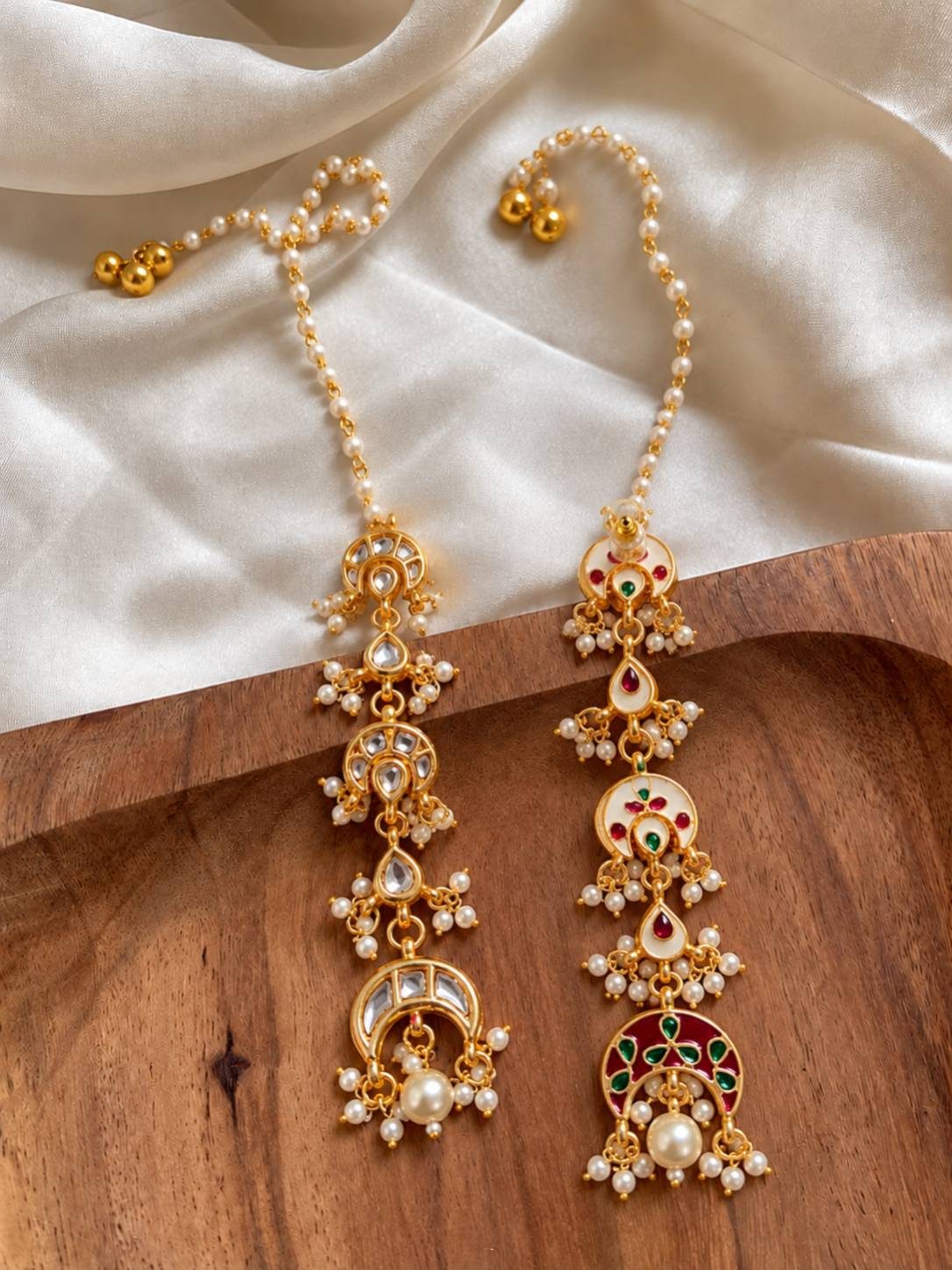 Side-by-side comparison of kundan-only and multicolour meenakari versions of the chandbali earrings on wood