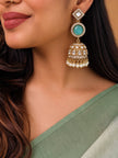 Woman wearing gold-plated kundan jhumka earring with turquoise stone and pearl drops, styled with a sage green saree