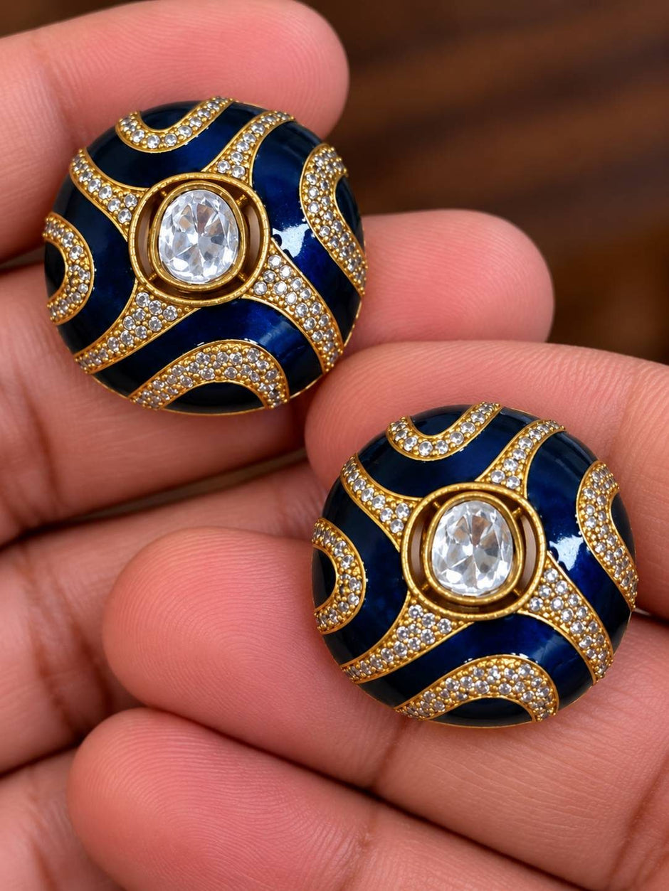 Close-up of two blue enamel kundan dome studs held in hand showing zirconia pave detail and polki-style centre stone