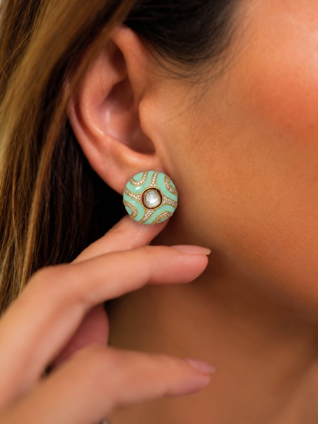 Woman wearing mint green enamel kundan button stud earring on her right ear