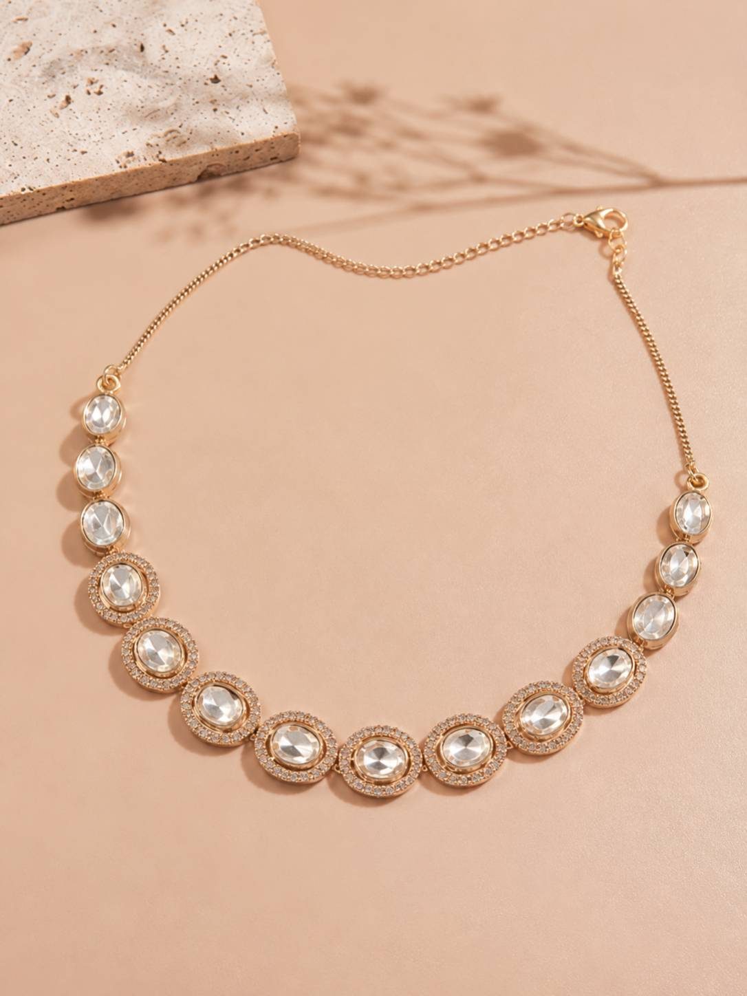 Rose gold oval kundan stone necklace laid flat showing full length and lobster clasp extender