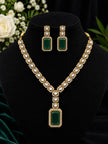 Gold-plated kundan necklace set with emerald green rectangular pendant and matching drop earrings displayed on black jewellery bust