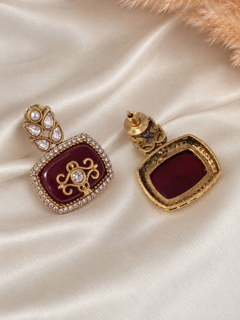 Front and back view of maroon kundan square drop earring showing stud mechanism on white satin