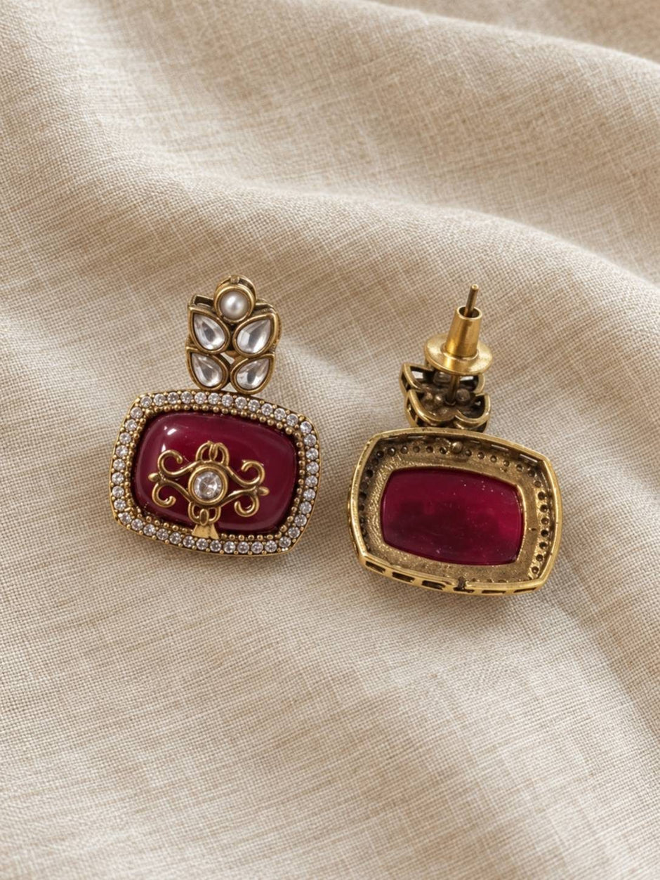 Front and back view of maroon enamel gold-plated kundan stud earring showing push-back fitting and reverse side construction