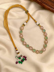 Gold-plated pink and green stone choker necklace laid flat showing adjustable gold dori tie-back closure with beaded tassel