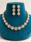 Gold-plated pink cabochon stone choker necklace and drop earring set displayed on a teal velvet jewellery bust