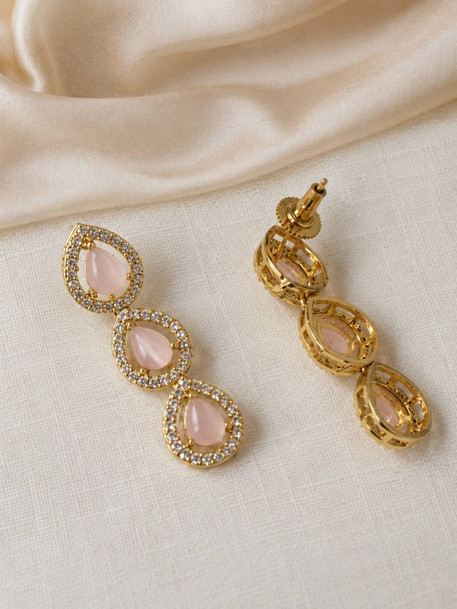 Close-up of three-tier gold-plated pink stone drop earrings showing front and reverse with push-back fittings
