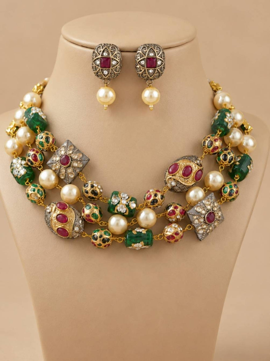 Three-layer Kundan pearl choker necklace set displayed on a beige bust with matching square oxidised stud earrings