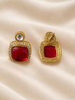 Front and back view of gold-plated red cabochon drop earrings with round kundan stud top and pavé halo border on cream fabric