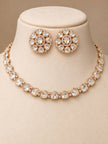 Rose gold polki choker necklace and floral stud earring set displayed on a beige jewellery bust