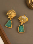 Close-up of gold shell stud earrings with teal green stone drops, reverse side visible