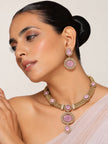Model wearing gold-plated pink stone choker necklace set with matching earrings styled with a blush saree