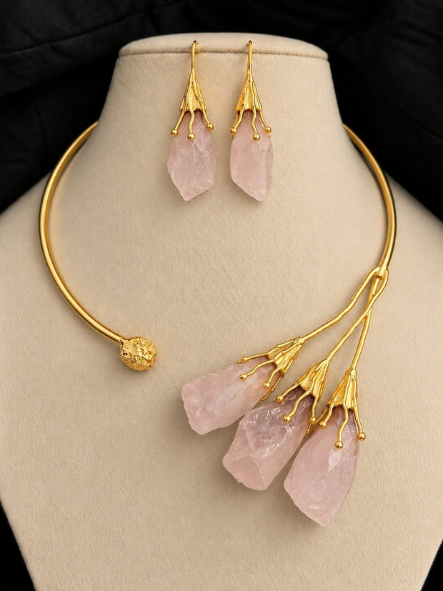 Gold-plated choker necklace and matching drop earring set displayed on a cream jewellery bust