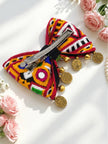 Back view of Kutchi embroidered bow hair clip showing silver alligator clip fastening with gold coin charms and ghungroo bells