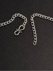 Close-up of S-hook clasp and adjustable extender chain for the oxidised silver choker necklace