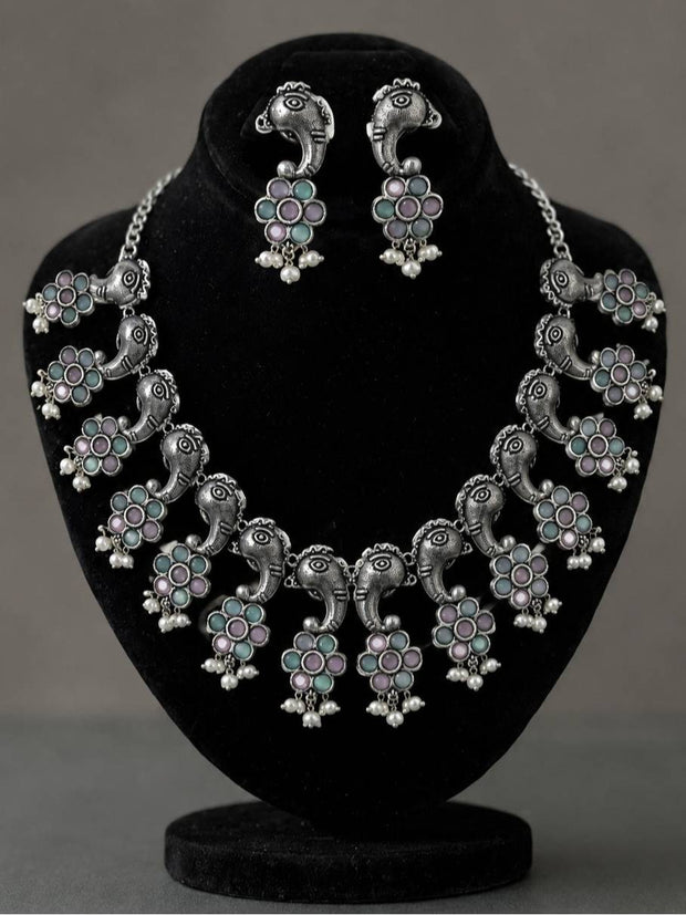 Oxidised silver Ganesha choker necklace and matching stud earrings displayed on a black velvet jewellery bust