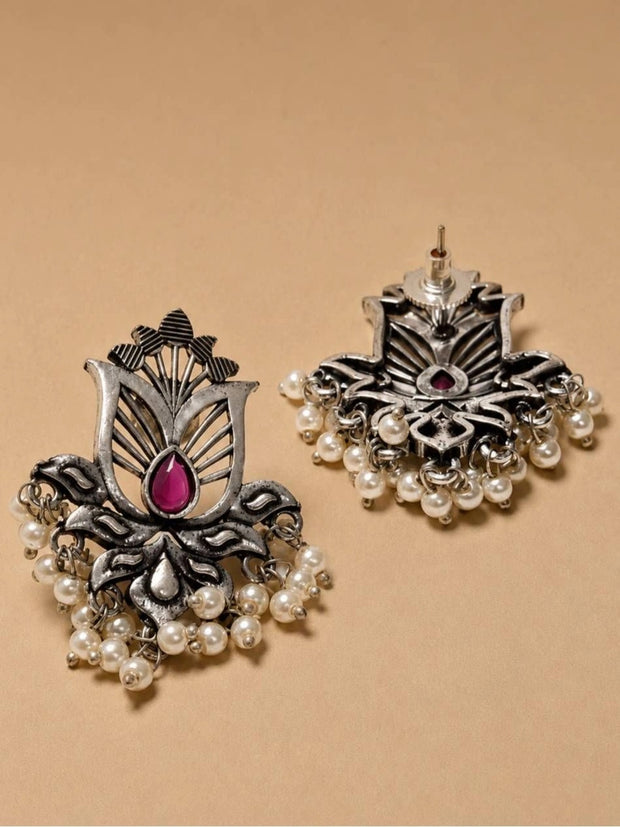 Front and reverse view of oxidised silver lotus studs showing pearl drops and push-back stud post on beige background