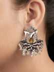 Oxidised silver lotus stud earring with pearl drops worn on a model's ear showing full size