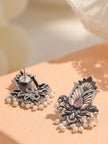 Back and front view of oxidised silver lotus earrings showing stud post and pearl fringe on peach surface