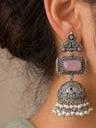 Oxidised silver jhumka earring worn on a woman's ear showing full length and pearl drops