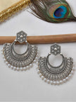 Front view of oxidised silver chandbali earrings showing dotwork detail and white pearl bead fringe