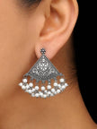 Single oxidised silver chandbali earring with white pearl drops worn on a woman's ear