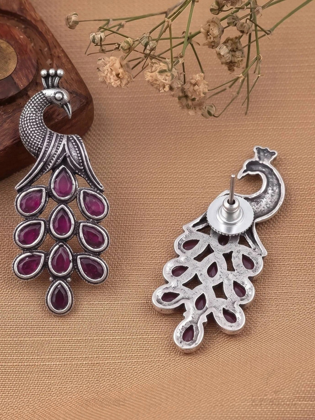 Front and back view of oxidised silver peacock earring showing stud back and butterfly clutch